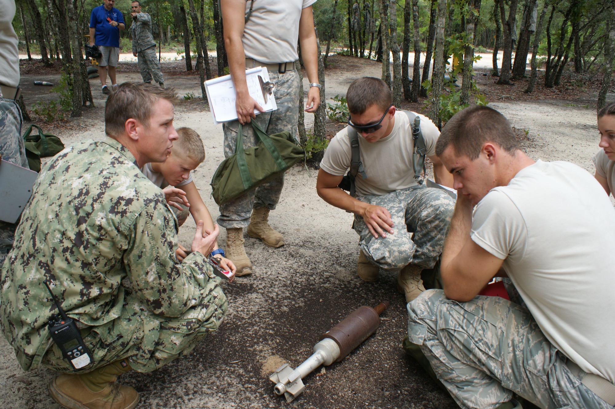 Navy Petty Officer First Class Chris Vann (left), EOD instructor, dissects a recon training problem during Core Division training Jul. 19, 2012, at Eglin Air Force Base, Fla.  NAVSCOLEOD encompasses nine division over 143 academic days . (U.S. Air Force photo/Dan Hawkins)