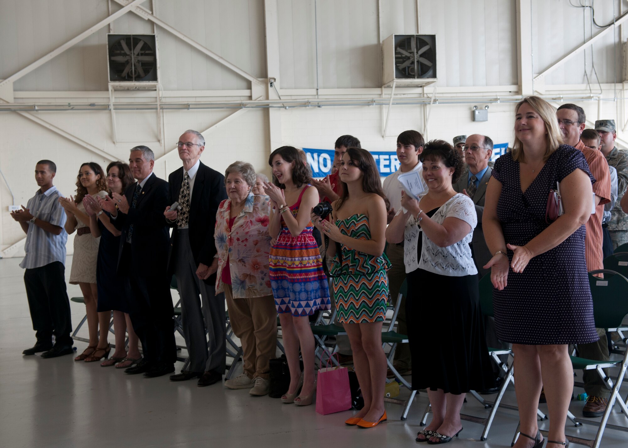 Family and friends clap after U.S. Air Force Col. Alvis Headen assumed command of the 23d Medical Group and Col. Mike Koppen was relieved during a change of command ceremony July 27, 2012, at Moody Air Force Base, Ga.  (U.S. Air Force photo by Senior Airman Eileen Meier/Released)