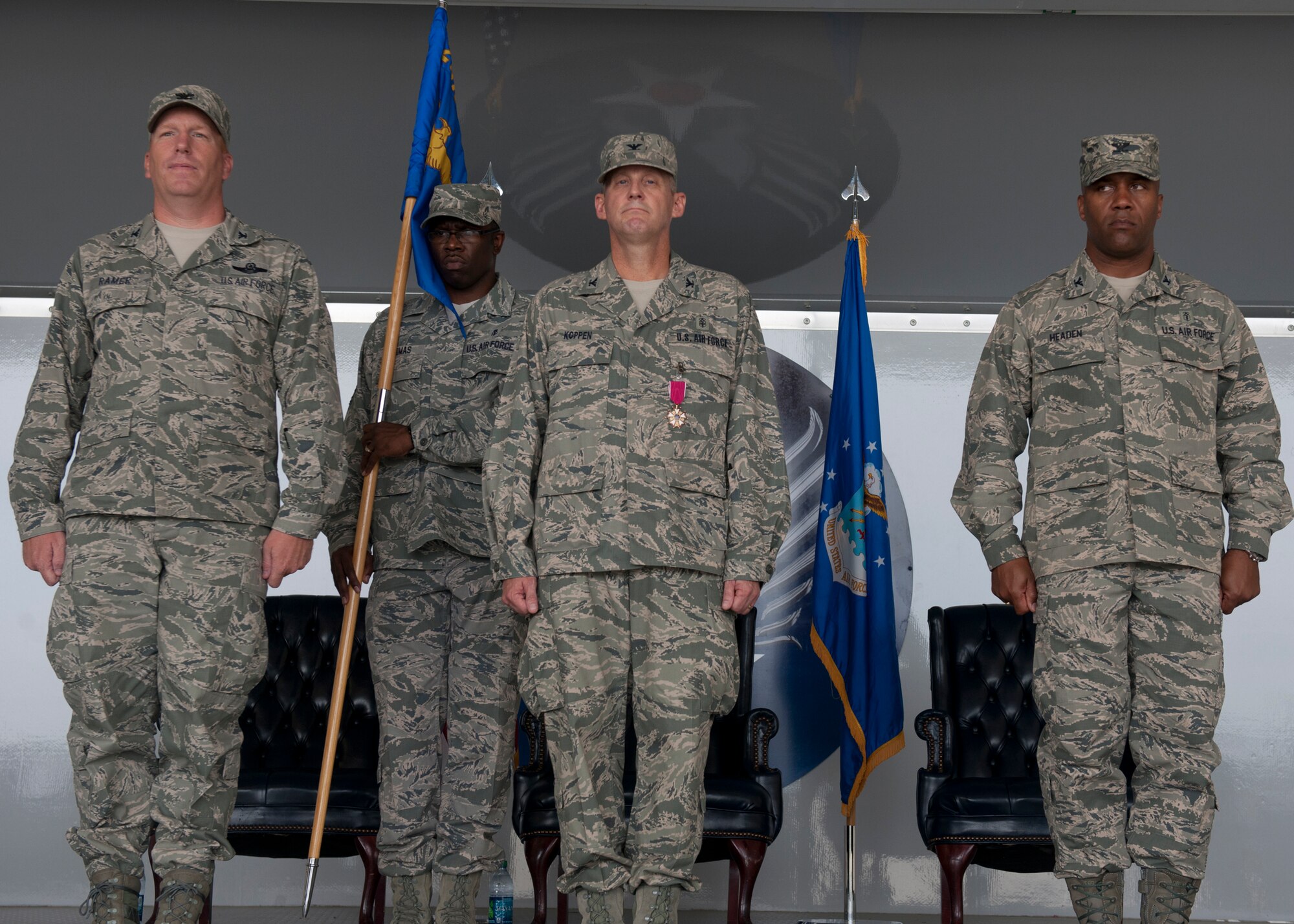 U.S. Air Force Colonels Steven Ramer, 23d Wing vice commander, Mike Koppen, former 23d Medical Group commander and Alvis Headen, new 23d MDG commander, perform the change of command ceremony July 27, 2012, at Moody Air Force Base, Ga. Koppen was relieved from the 23d MDG as commander and Headen assumed command. (U.S. Air Force photo by Senior Airman Eileen Meier/Released)