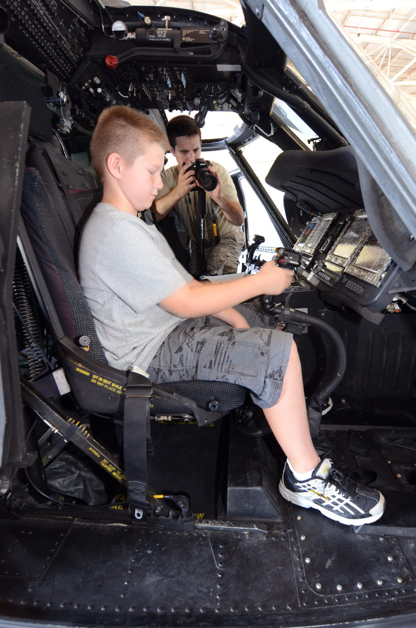 Garrett Manning, son of Lt. Col. Erin Manning from the 94th Mission Support Group, sizes up the controls of a Blackhawk helicopter at the annual Bring Your Kids to Work Day at Dobbins Air Reserve Base, July 27. Members of Dobbins ARB were able to bring their kids to their places of work, then to a hangar with several hands-on displays of equipment utilized on the base and also to the C-130 flight simulator.  (U.S. Air Force photo/Brad Fallin)