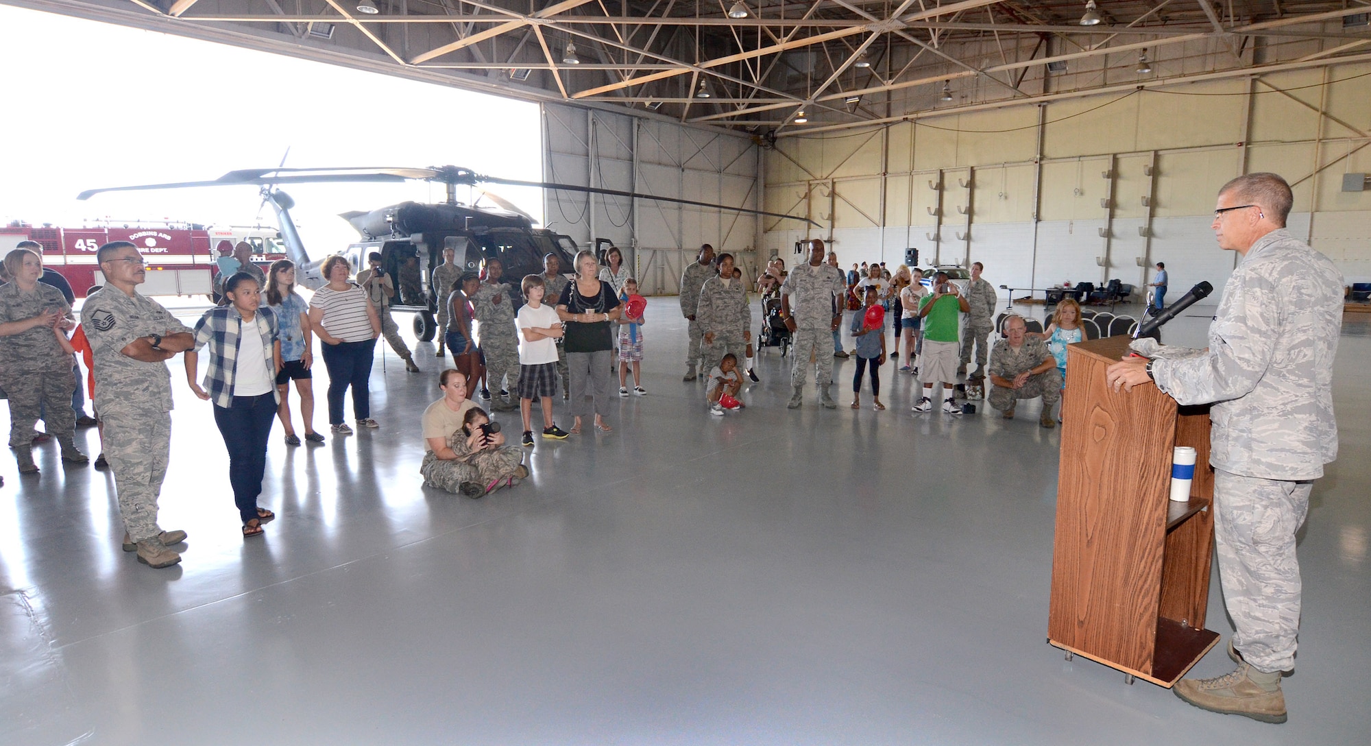 Col. Tim Tarchick, 94th Airlift Wing commander, addresses the kids and parents attending the annual Bring Your Kids to Work Day at Dobbins Air Reserve Base, July 27. Members of Dobbins ARB were able to bring their kids to their places of work, then to a hangar with several hands-on displays of equipment utilized on the base and also to the C-130 flight simulator.  (U.S. Air Force photo/Brad Fallin)