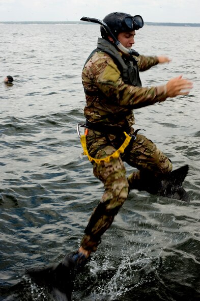 A pararescueman of 23rd Special Tactics Squadron jumps into the water to save victims from a simulated plane crash during a aquatic survival exercise at a training area near Hurlburt Field, Fla., July 24, 2012. Several volunteer players with simulated injuries were deployed into the water to be saved and hoisted up to a helicopter to safety. (U.S Air Force photo/Senior Airman Eboni Reams)
