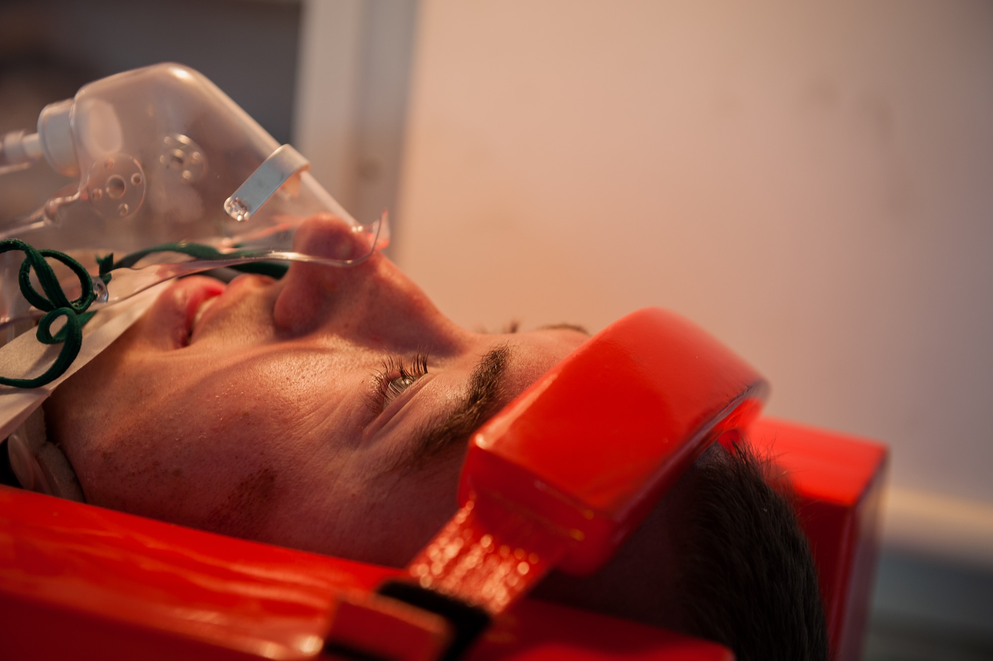 Staff Sgt. Ezekiel Newman, 65th Communication Squadron, receives medical attention for a simulated neck injury during a joint exercise at Lajes Field, July 30 2012. Lajes Airmen teamed up their Portuguese counterparts and practiced emergency procedures for a possible downed aircraft prior to the upcoming Open House on Aug. 5th.  (Photo by Lucas Silva)