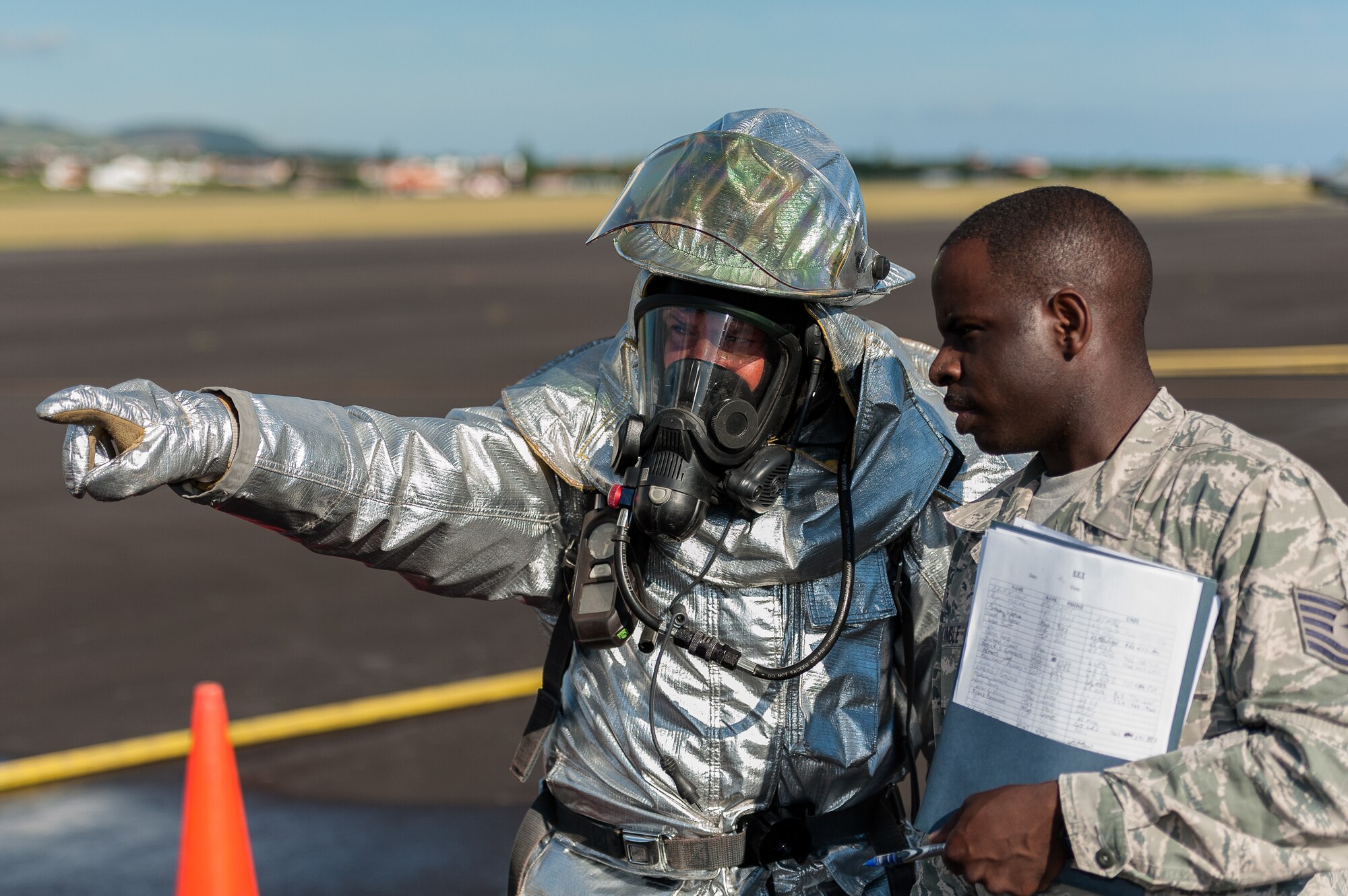 Dimas Martins, 65th Civil Engineer Squadron firefighter explains his evacuation procedure plan with Tech. Sgt. Floydzell Kimble, 65th CES exercise evaluator, during a joint exercise at Lajes Field, July 30 2012.  Lajes Airmen and their Portuguese partner’s exercised solidarity as they put into practice emergency procedures for a downed aircraft prior to the upcoming Open House on Aug.  5th. (Photo by Lucas Silva)