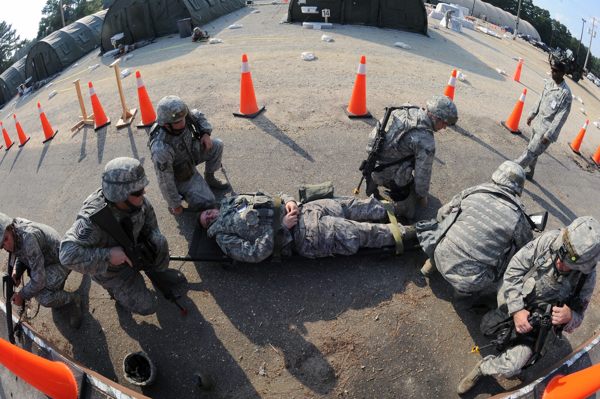 Airmen prepare to transport a simulated patient after performing self aid buddy care during an operational readiness exercise on Seymour Johnson Air Force Base, N.C., July 26, 2012. SABC is the process of treating injured or wounded personnel in the field until medical treatment can be administered. (U.S. Air Force photo/Airman 1st Class John Nieves Camacho/Released)