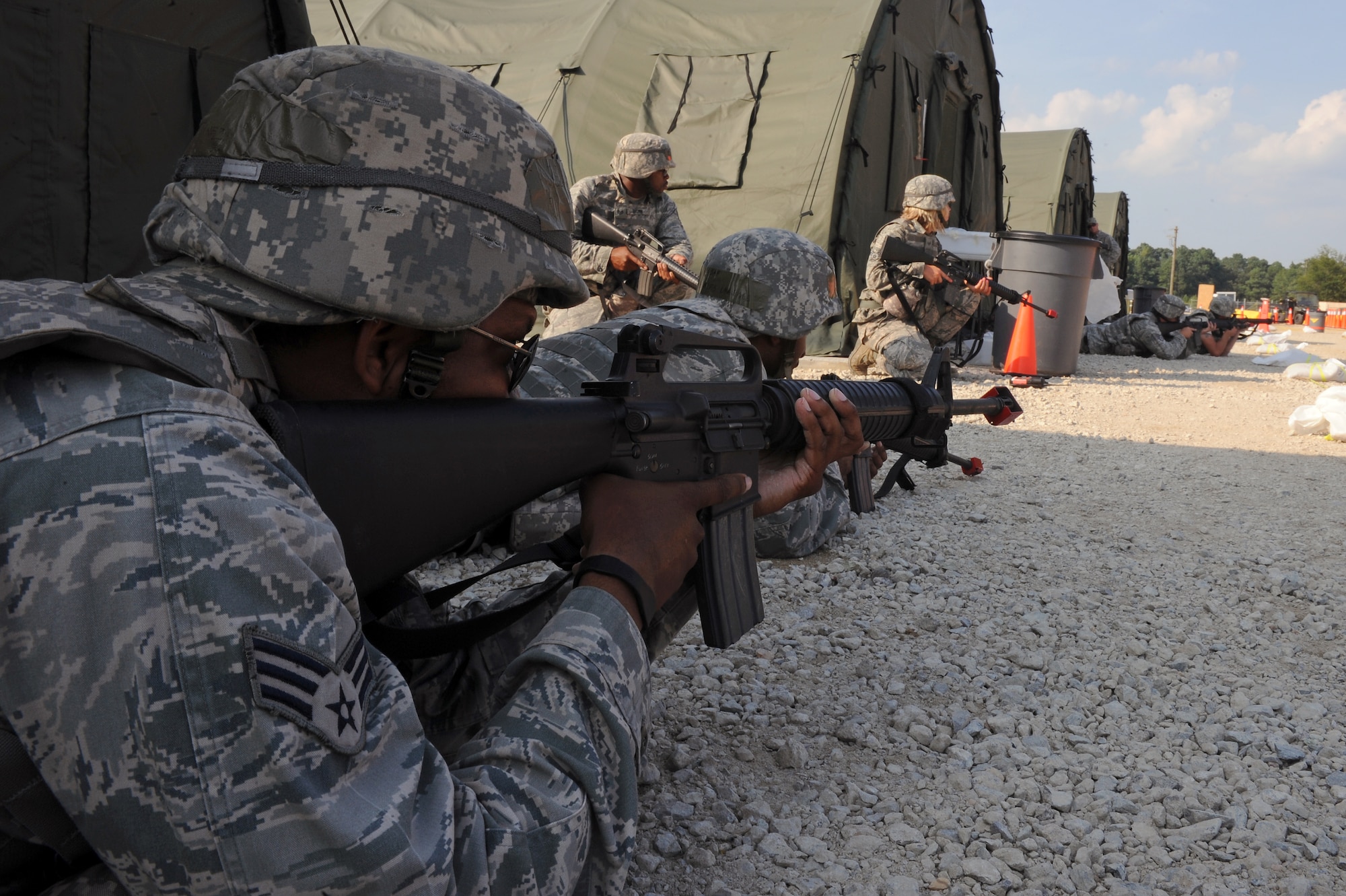 Airmen take defensive positions after hearing simulated gunshots near Base X during an operational readiness exercise on Seymour Johnson Air Force Base, N.C., July 26, 2012. Security Forces Airmen are trained and equipped to combat all threats that come to the base. (U.S. Air Force photo/Airman 1st Class John Nieves Camacho/Released)