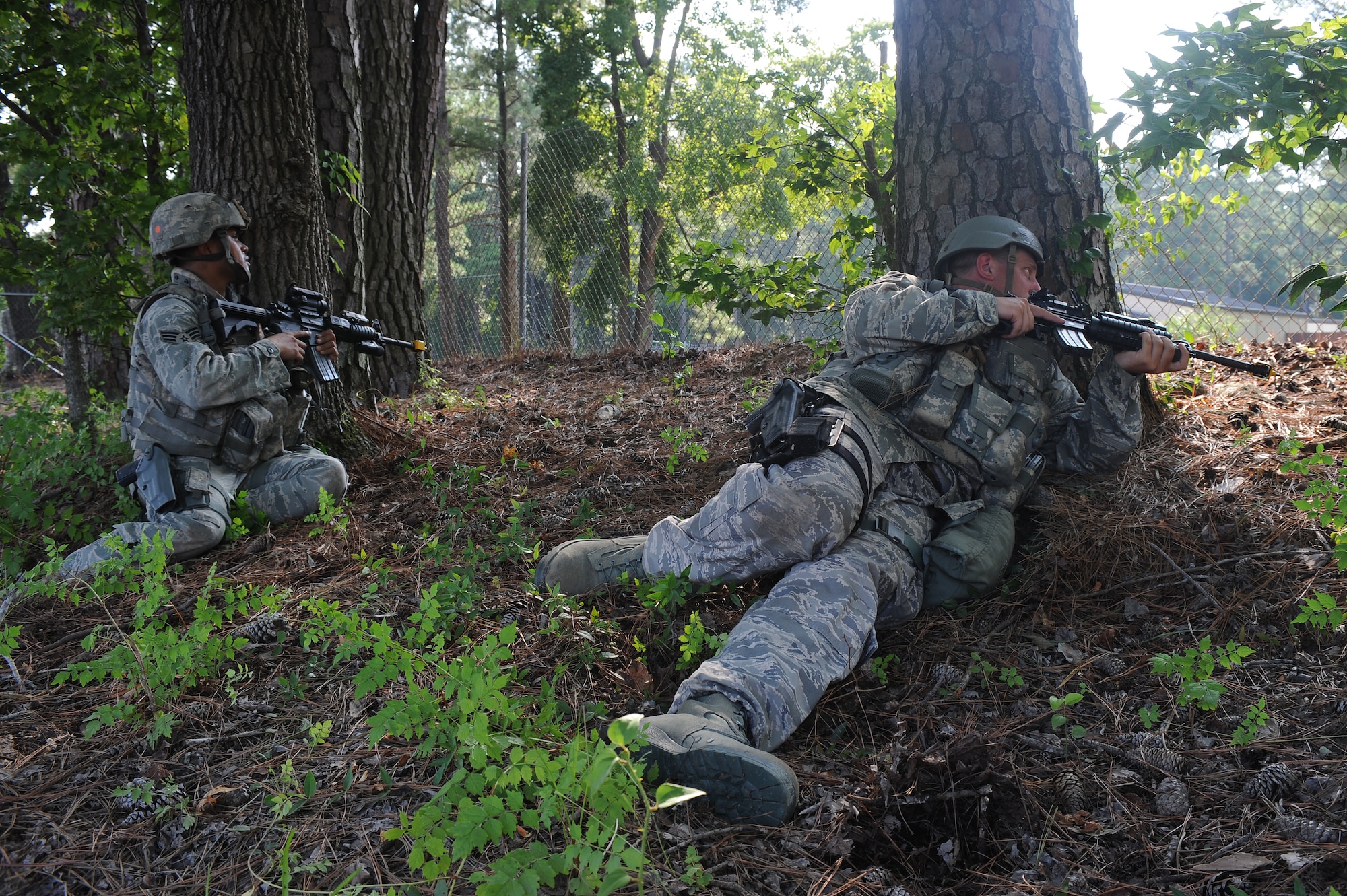 U.S. Air Force Senior Airman Matthew Watkins (left), 4th Security Forces Squadron force protector, and Staff Sgt. Kent Irving, 4th SFS flight chief, observe the perimeter of Base X during an operational readiness exercise on Seymour Johnson Air Force Base, N.C., July 26, 2012. Various simulations were conducted during the exercise to test Airmen’s abilities to react and respond. (U.S. Air Force photo/Airman 1st Class John Nieves Camacho/Released)
