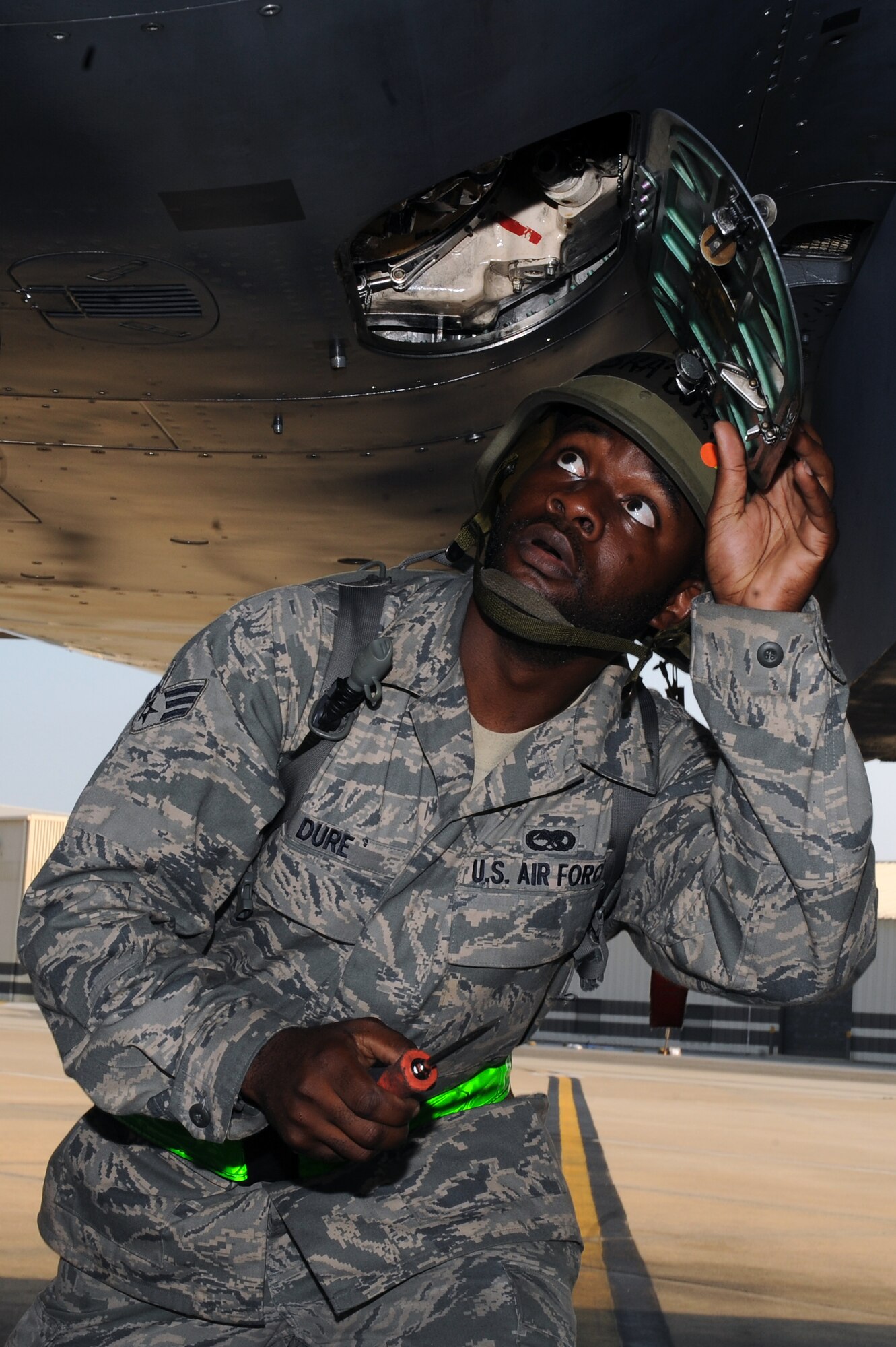 U.S. Air Force Senior Airman Marvin Dure, 4th Aircraft Maintenance Squadron crew chief, performs service checks on an F-15E Strike Eagle during an operational readiness exercise on Seymour Johnson Air Force Base, N.C., July 26, 2012. During the exercise, Airmen highlight their ability to position, employ and sustain forces in a deployed environment. (U.S. Air Force photo/Airman 1st Class John Nieves Camacho/Released)