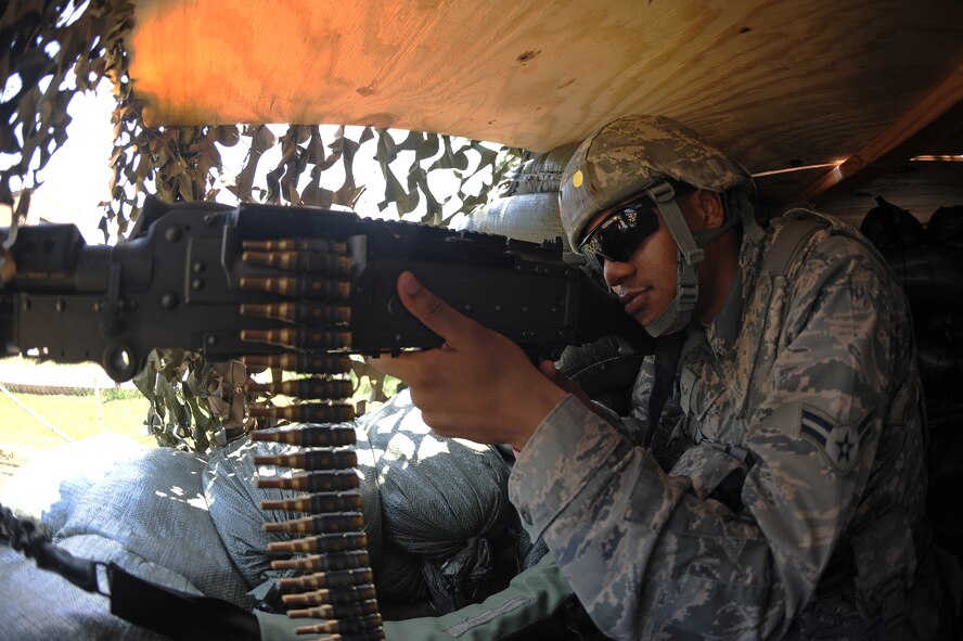 U.S. Air Force Airman 1st Class Michael Mandel, 4th Security Forces Squadron force protector, scans the perimeter of Base X with a M240-Bravo during an operational readiness exercise on Seymour Johnson Air Force Base, N.C., July 26, 2012.  The M240-Bravo weighs 27.6 pounds and fires 200 rounds per minute. (U.S. Air Force photo/Airman 1st Class John Nieves Camacho/Released)