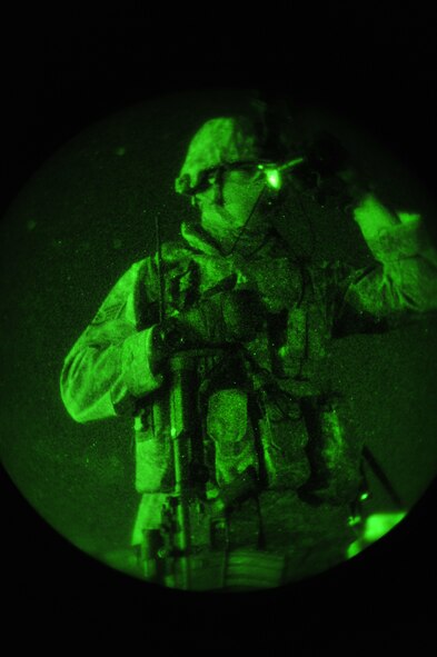 U.S. Air Force Staff Sgt. Douglas Freeman, 27th Special Operations Security Forces Squadron Special Operations Forces Fly Away Security Team member, uses thermal night vision goggles to survey the area during a night training mission at Cannon Air Force Base, N.M., July 19, 2012. The mission of SOF FAST members is to protect the aircraft and crew through flight deck denial and ground security. (U.S. Air Force photo/Airman 1st Class Eboni Reece)