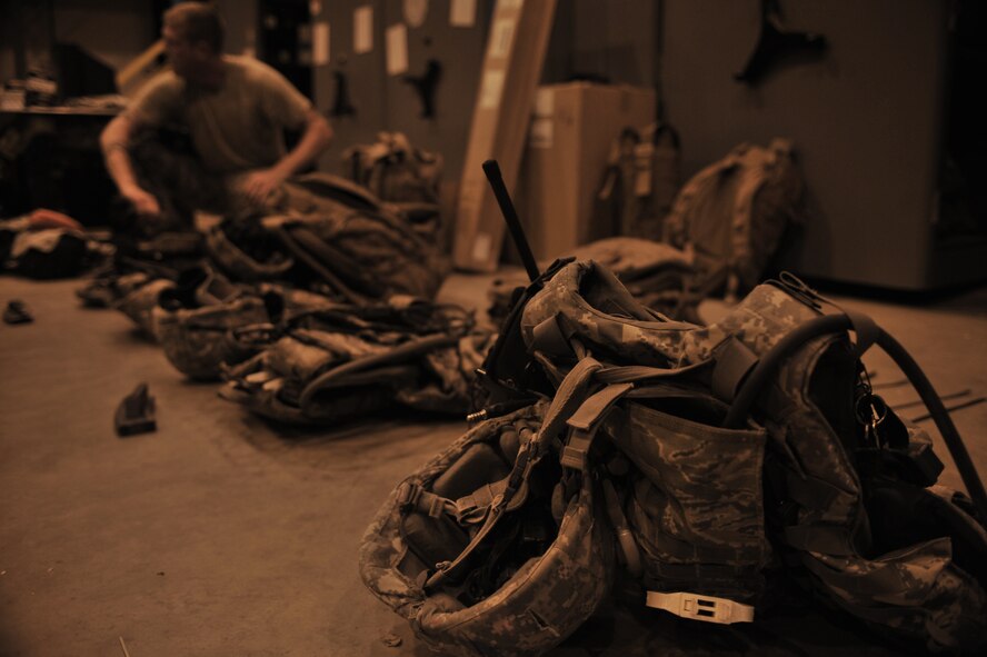 U.S. Air Force Staff Sgt. Matthew Kline, 27th Special Operations Security Forces Squadron Special Operations Forces Fly Away Security Team member, assembles gear for a night training mission at Cannon Air Force Base, N.M., July 19, 2012. The mission of SOF FAST members is to protect the aircraft and crew through flight deck denial and ground security. (U.S. Air Force photo/Airman 1st Class Eboni Reece)