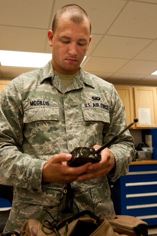 Airman 1st Class Christopher Mcgillis, 28th Operations Support Squadron aircrew flight equipment technician, tests a handheld radio from an aircrew survival vest during a routine inspection at the 34th Bomb Squadron on Ellsworth Air Force Base, S.D., July 25, 2012. Radios, which are quality inspected every 60 days, are an aircrew member’s main form of communication in case they are forced to eject from a B-1 and should be quality inspected every 60 days. (U.S. Air Force photo by Airman 1st Class Kate Thornton/Released) 