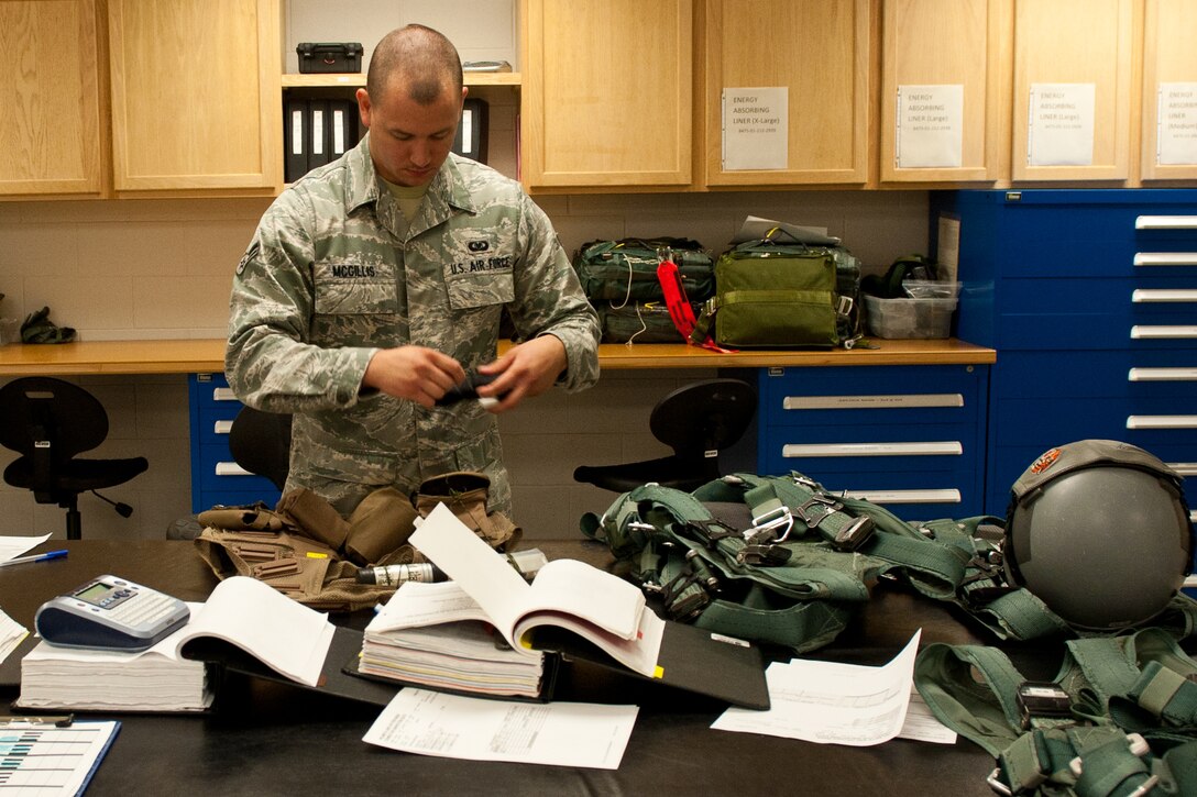 Airman 1st Class Christopher Mcgillis, 28th Operations Support Squadron aircrew flight equipment technician, inspects an aircrew survival vest during a routine inspection at the 34th Bomb Squadron on Ellsworth Air Force Base, S.D., July 25, 2012. AFE technicians are responsible for maintaining all survival equipment B-1 aircrews need during training missions. (U.S. Air Force photo by Airman 1st Class Kate Thornton/Released)