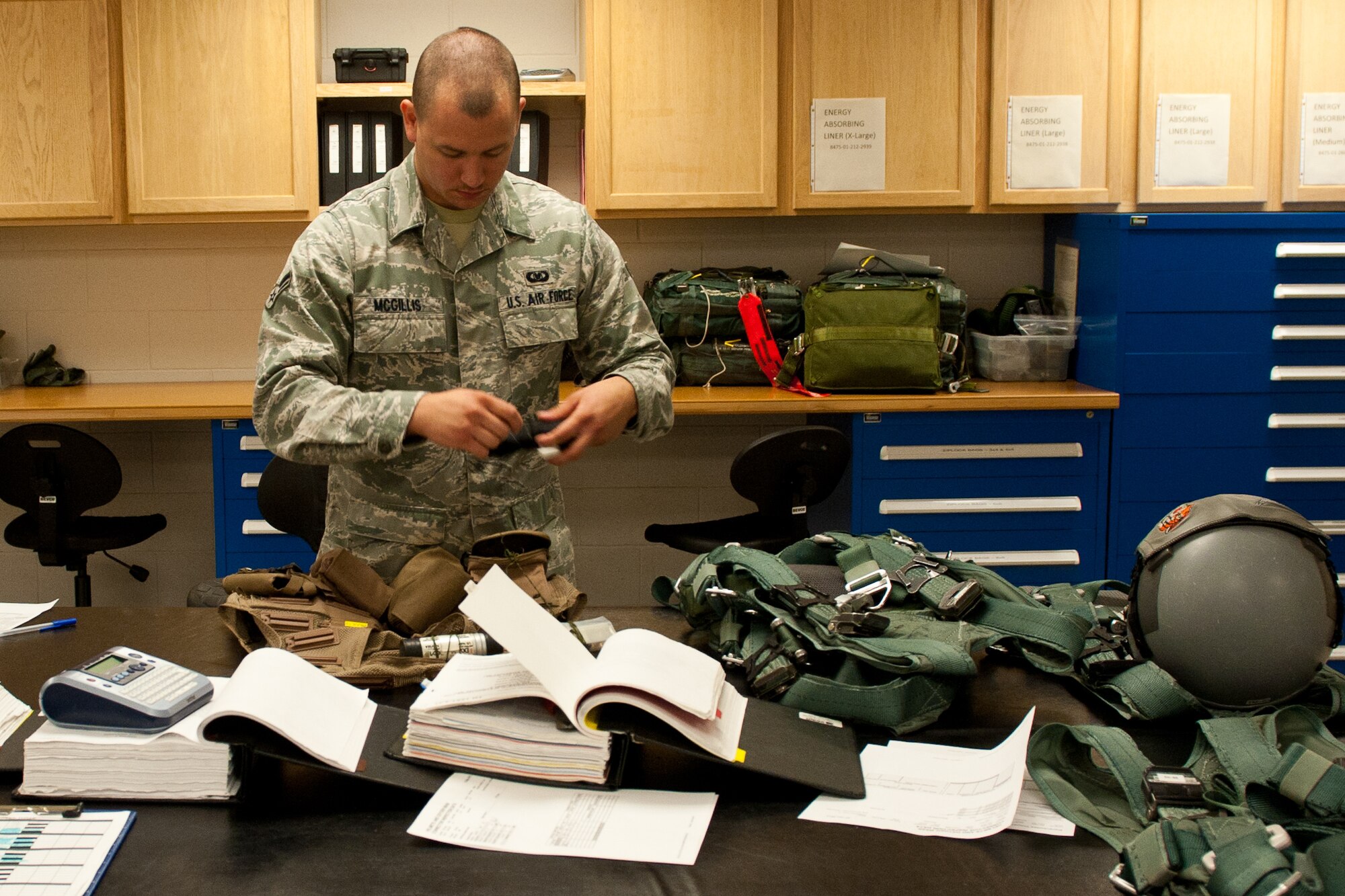 Airman 1st Class Christopher Mcgillis, 28th Operations Support Squadron aircrew flight equipment technician, inspects an aircrew survival vest during a routine inspection at the 34th Bomb Squadron on Ellsworth Air Force Base, S.D., July 25, 2012. AFE technicians are responsible for maintaining all survival equipment B-1 aircrews need during training missions. (U.S. Air Force photo by Airman 1st Class Kate Thornton/Released)