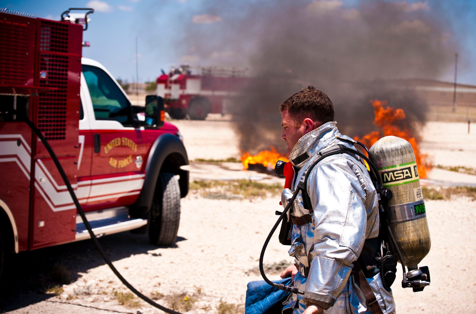 A firefighter from the Laughlin Fire Department gets ready to participate in a live-fire training exercise at Laughlin Air Force Base, Texas, July 24, 2012. The fire department conducted their first day of hands-on training with the new P-34 Rapid Intervention Vehicle. The Air Force is switching to the new vehicle because of its high foam and water pressure combination is more effective than the older P-19 vehicle. (U.S. Air Force photo/Senior Airman Scott Saldukas)