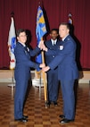 Brig. Gen. Theresa C. Carter, Joint Base San Antonio and 502nd Air Base Wing commander, passes the 802nd Mission Support Group guidon to Col. William A. Eger III, July 16 at JBSA-Lackland. The ceremony and passing of the unit guidon symbolizes Eger’s role as the new commander of the organization. (U.S. Air Force photo/Alan Boedeker)