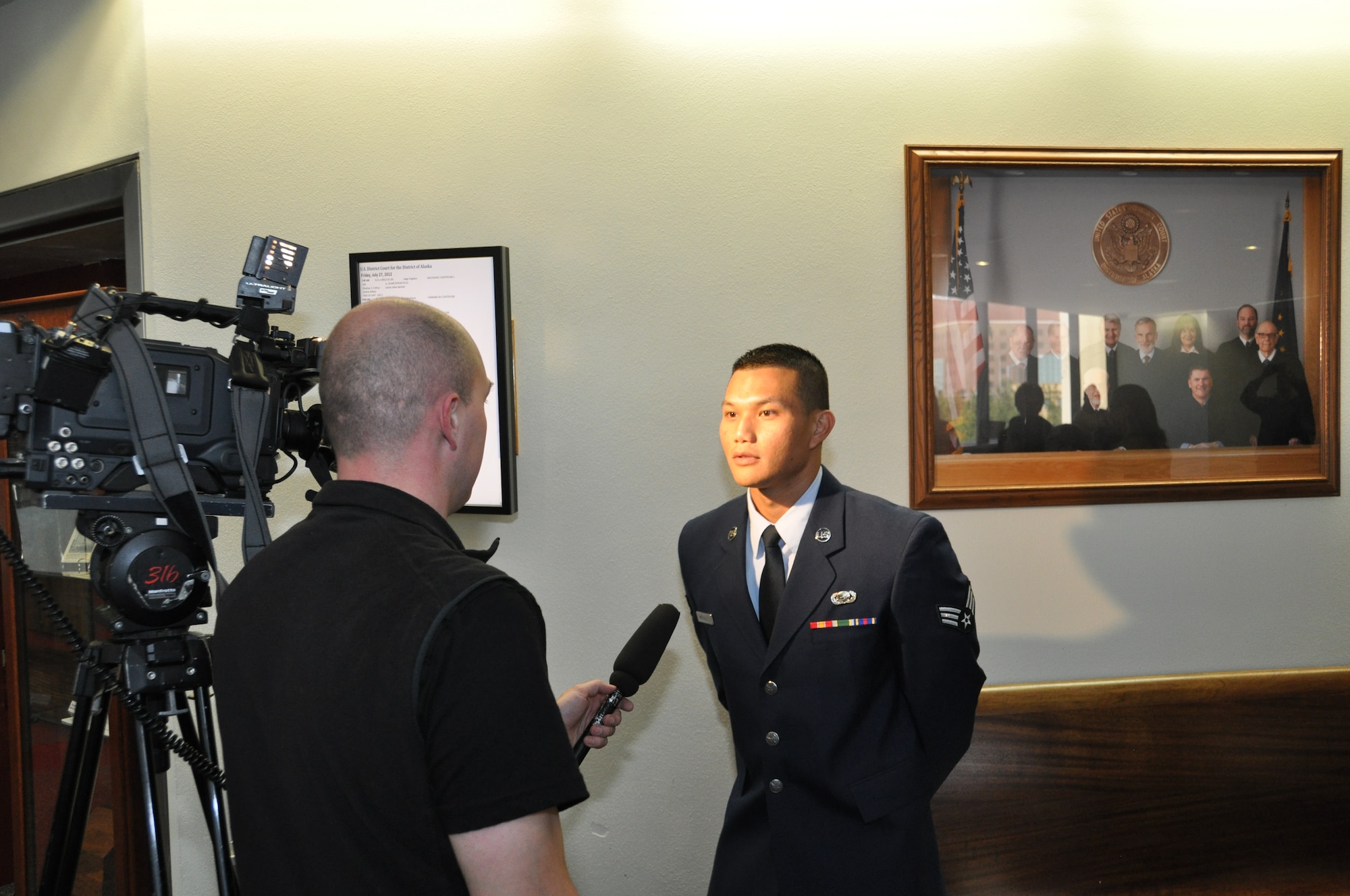 Following the ceremony to become a U.S. citizen, Senior Airman Noel Magcalas was interviewed by Anchorage CBS affiliate KTVA.  Magcalas came to the U. S. in 1996 and joined the Air Force Reserve in 2010. He is one of 32,000 U.S. military members serving as legal residents in hopes of attaining citizenship. (U.S. Air Force Photo/Tech. Sgt. Dana Rosso) 