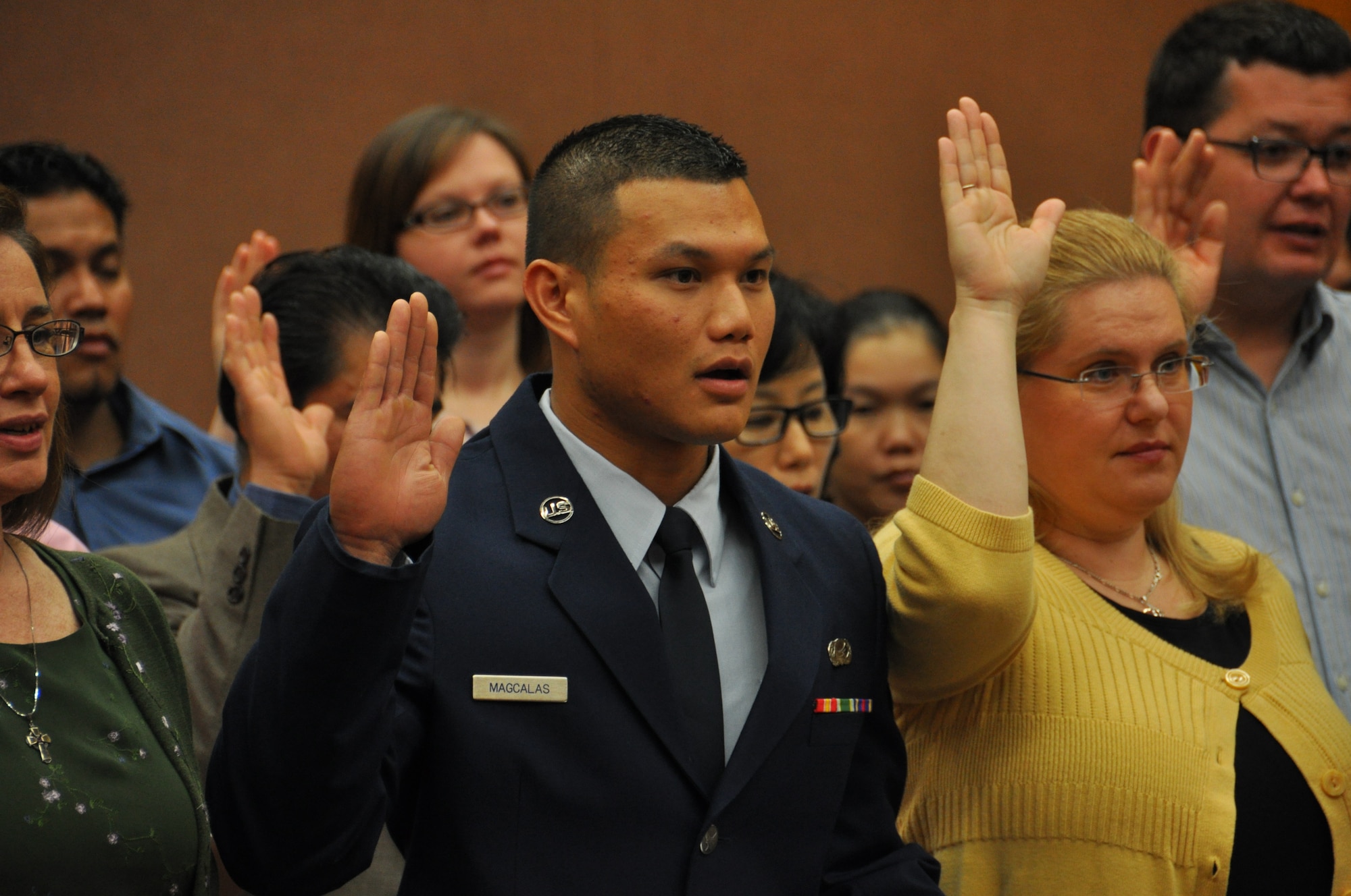 Senior Airman Noel Magcalas takes the Oath of Allegiance during a Naturalization Ceremony in Anchorage July 27. Magcalas came to the U. S. in 1996 and joined the Air Force Reserve in 2010. (U.S. Air Force Photo/Tech. Sgt. Dana Rosso) 