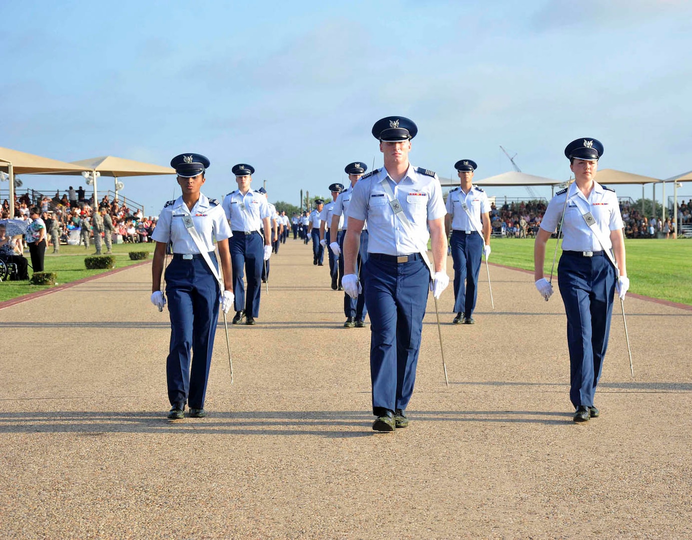 From left to right, U.S. Air Force Academy Cadet 2nd Class Nicque Robinson, Commander of Airmen Cadet 1st Class Joshua Hall, and Cadet 1st Class Christina Beckett lead the formation during practice just prior to the Air Force Basic Military Training graduation ceremony July 13 at the BMT parade grounds. Twenty-seven cadets from the academy’s current junior class shadowed military training instructors as part of the Cadet Summer Leadership Program. The seven-week visit culminated with cadets leading key positions during the BMT graduation ceremony. (U.S. Air Force photo/Alan Boedeker)