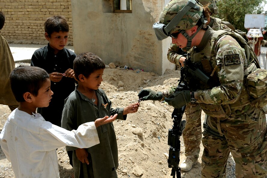 Capt. Leslee Kane gives candy to local children in Qalat City, Afghanistan, Aug. 10. Kane is a member of Provincial Reconstruction Team Zabul and is deployed from Fairchild Air Force Base, Wash. PRT Zabul is comprised of Air Force, Army, Department of State, U.S. Agency for International Development, U.S. Department of Agriculture, and U.S. Army Corps of Engineers personnel who work with the government of Afghanistan to improve governance, stability, and development throughout the province. (U.S. Air Force photo by Senior Airman Grovert Fuentes-Contreras)