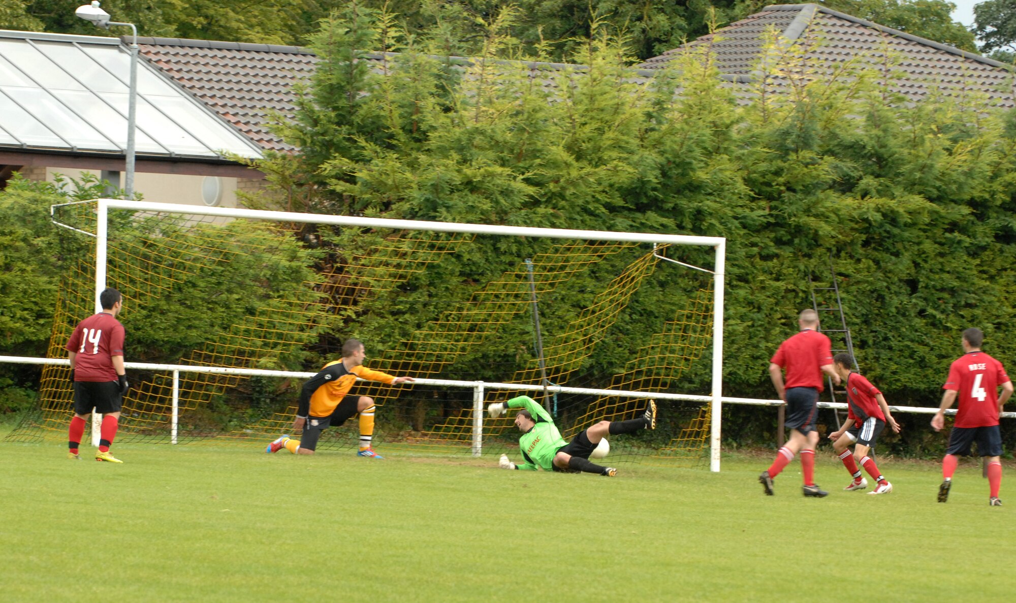 MILDENHALL, England – The goalie for Mildenhall Town Football Club in the green jersey, attempts to block a goal from the RAF Mildenhall soccer team during a soccer match July 29, 2012 at the MTFC pitch in Mildenhall. This was the only goal allowed for the base team. MTFC won the match 14-1. (U.S. Air Force photo/Senior Airman Rachel Waller)