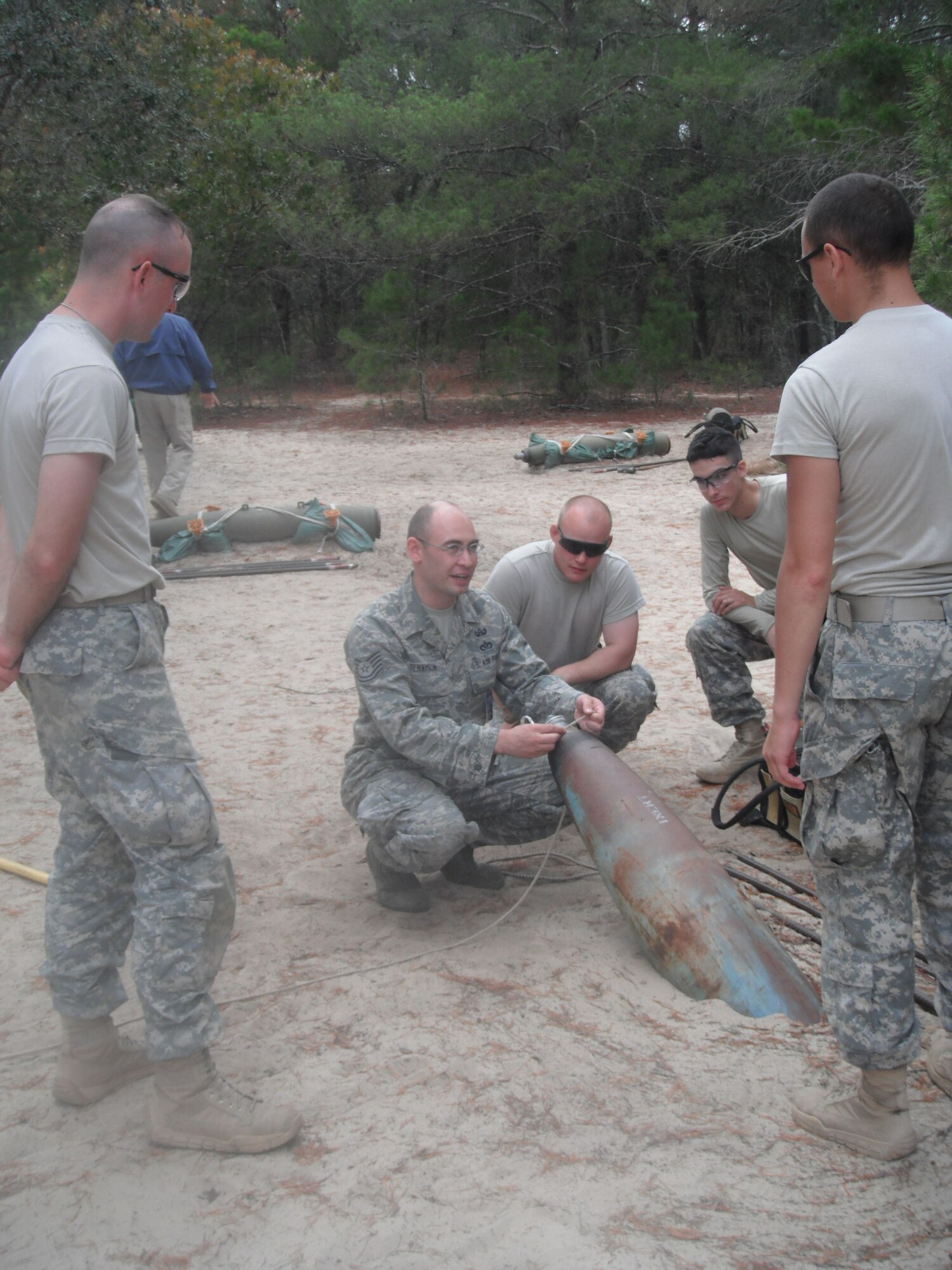 Tech. Sgt. Ryan Tennyson, an EOD instructor with the 366nd TRS Detachment 3 at Naval School Explosive Ordnance Disposal at Eglin Air Force Base, Fla., demonstrates tools and methods practices for students Nov. 11, 2011.  Tennyson, the 2011 AETC NCO Instructor of the Year, split the year between teaching at NAVSCOLEOD and deploying to Iraq as part of Task Force Troy.  (U.S. Air Force photo/Dan Hawkins)