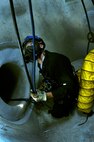 Senior Airman Justin Erikson, 21st Civil Engineer Squadron firefighter from Peterson Air Force Base, waits for instruction during the hands-on confined space training July 26 at Schriever as part of their Rescue 1 Technician course. Twelve firefighters from Schriever, Peterson Air Force Base, Cheyenne Mountain Air Force Station and U.S. Air Force Academy participated in three days of classroom training before applying what they learned in various scenarios during 12 days of hands-on training. (U.S. Air Force photo/Staff Sgt. Julius Delos Reyes)