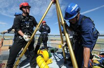 Front Range firefighters set up a tripod during the hands-on confined space training July 26 at Schriever as part of their Rescue 1 Technician course. Twelve firefighters from Schriever, Peterson Air Force Base, Cheyenne Mountain Air Force Station and U.S. Air Force Academy participated in three days of classroom training before applying what they learned in various scenarios during 12 days of hands-on training. (U.S. Air Force photo/Staff Sgt. Julius Delos Reyes)