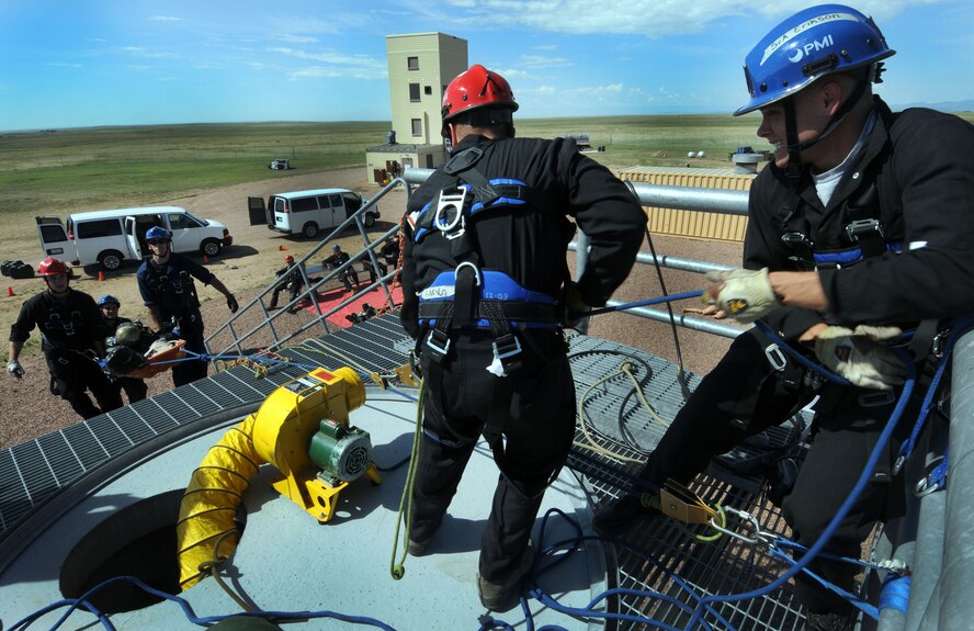 Airman 1st Class Tyler King (middle), 10th Civil Engineer Squadron firefighter, and Senior Airman Justin Erikson (right), 21st Civil Engineer Squadron firefighter, pull their teammates during the hands-on portion of the confined space training July 26 as part of Rescue 1 Technician course. The course is an advanced course designed for Department of Defense firefighters to teach them ropes courses, low-angles, high line systems and confined spaces. (U.S. Air Force photo/Staff Sgt. Julius Delos Reyes)