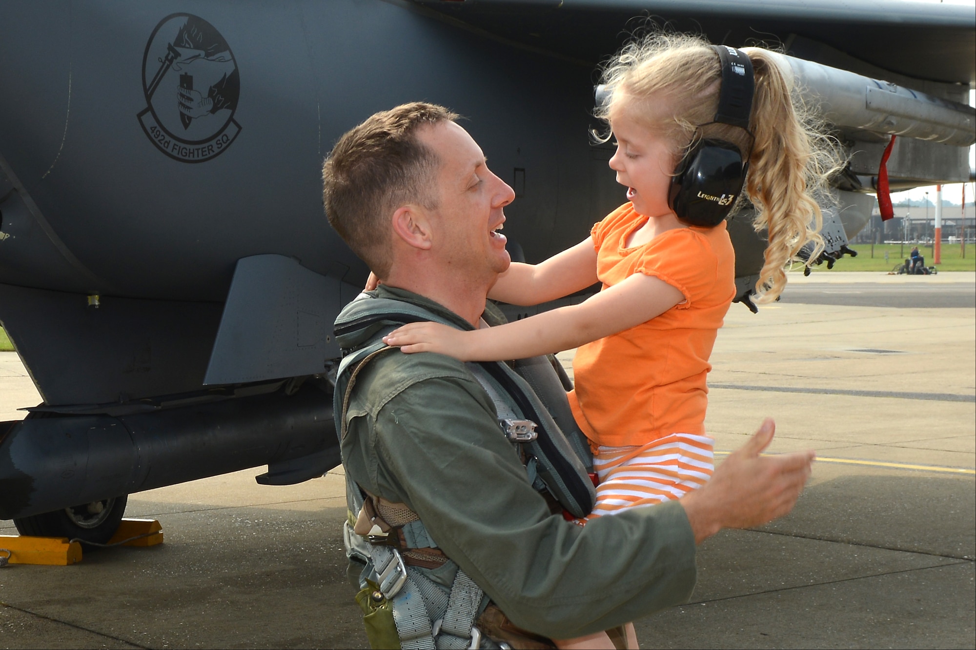 RAF LAKENHEATH, England - Taylor Browning, 4, greets her father, Master Sgt. Gabriel Browning, 422nd Communications Squadron, RAF Croughton, United Kingdom, after he climbed out of an F-15E Strike Eagle on the flightline when he finished his incentive flight July 27. Browning earned the flight as the 501st Combat Support Wing SNCO of the Year and his deployment where his unit lost nine people, including his boss and co-worker, to an Afghan gunman. (U.S. Air Force photo by Master Sgt. John Barton)