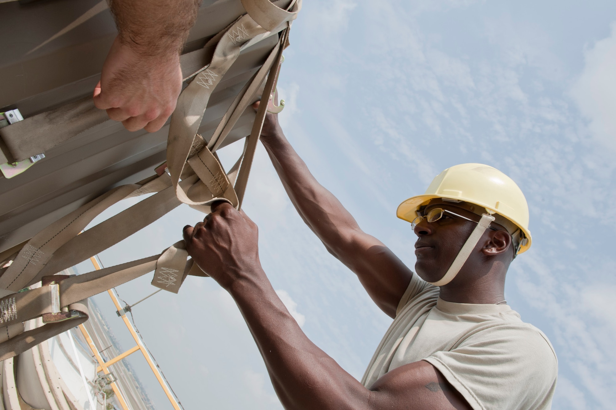 Senior Airman Michael Williams, 39th Communications Squadron ground radar maintenance technician, removes a safety harness from the new Portable Doppler Radar system July 27, 2012, at Incirlik Air Base, Turkey. The new system will replace the old Tactical Weather Radar system and will enhance weather predictability for both U.S. and Turkish forces at Incirlik. (U.S. Air Force photo by Senior Airman Anthony Sanchelli/Released) 
