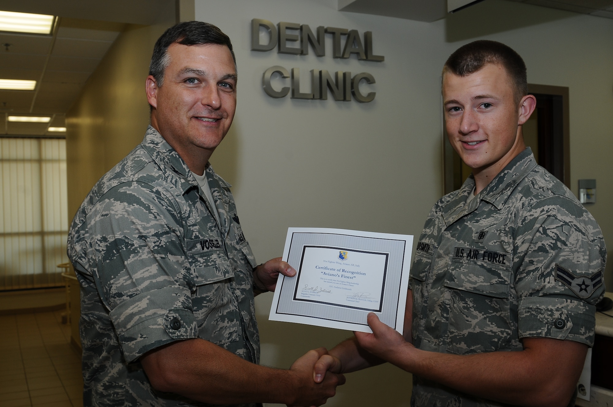 Col. Brent Vosseler, 31st Fighter Wing vice commander, recognizes Airman 1st Class Andrew Goldsmith, 31st Dental Squadron dental technician, as one of Aviano's Finest July 26, at Aviano Air Base.  Aviano's Finest is a commanders recognition program that identifies and honors Aviano Airmen for their work ethic, professinalism and commitment to the mission.(U.S. Air Force photo by Staff Sgt. Ryan Whitney)