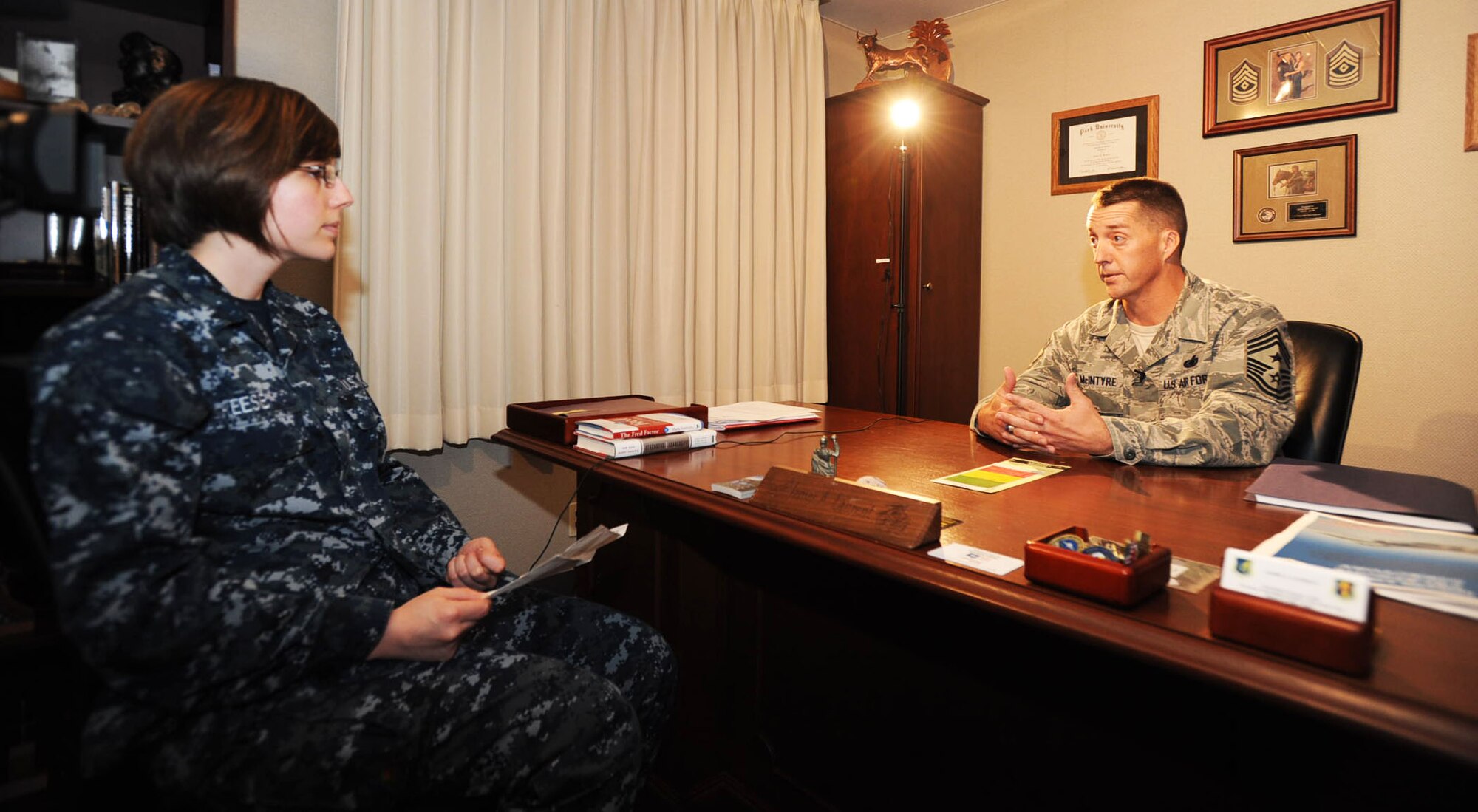 U.S. Air Force Chief Master Sgt. Douglas McIntyre, right, Command Chief Master Sergeant for the United States Forces Japan and Fifth Air Force, spoke with U.S. Navy Seaman Lisa Reese of Armed Forces Network-Misawa during a three day stay at Misawa Air Base, Japan, July 26, 2012. During the interview McIntyre touched on several topics, from future military changes to Misawa’s first bilateral senior NCO induction ceremony. (U.S. Air Force Airman 1st Class Kenna Jackson/Released)