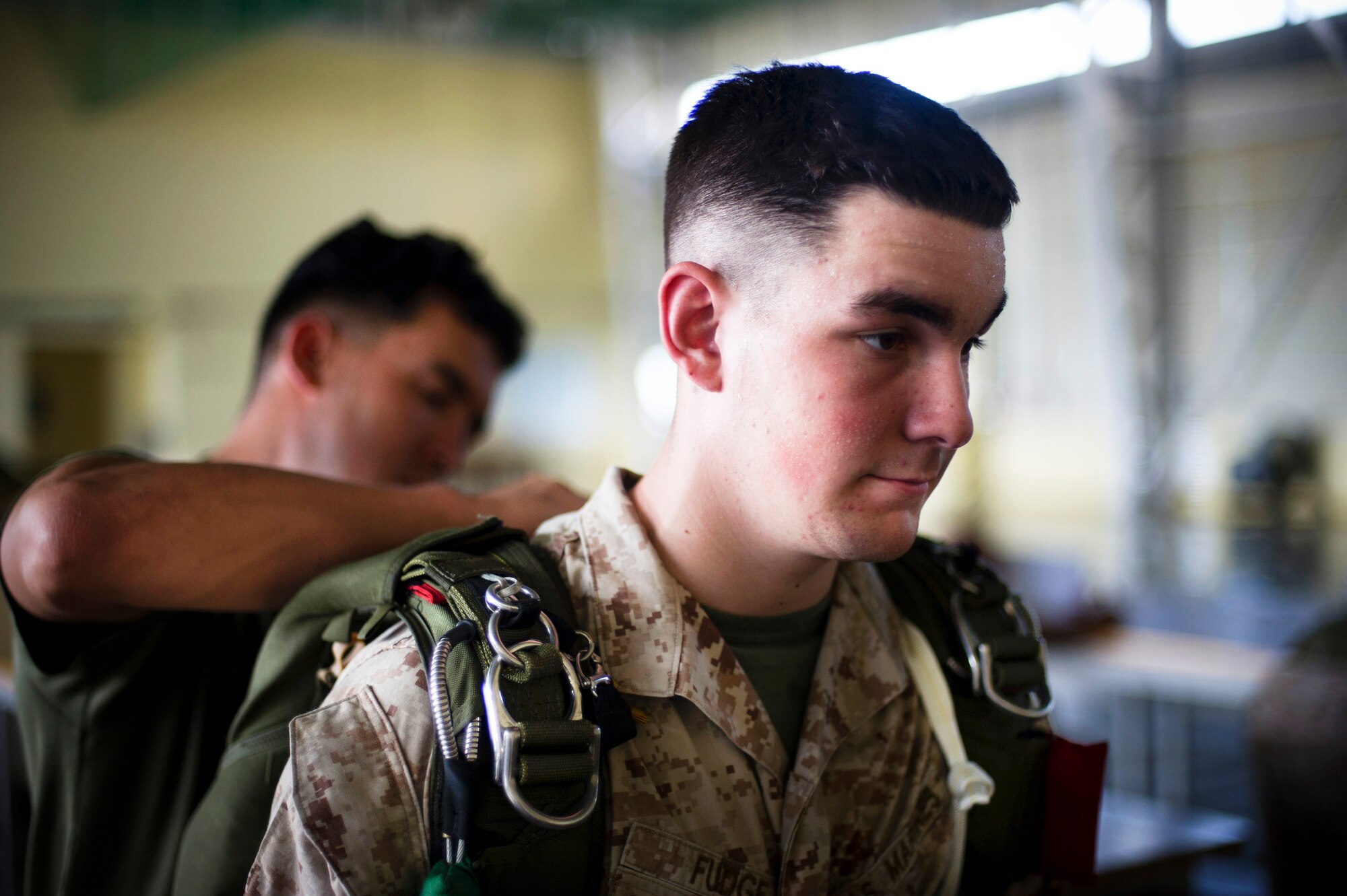 YOKOTA AIR BASE, Japan -- A Marine paratrooper assigned to the 31st Marine Expeditionary Unit from Okinawa, Japan, waits while his jumpmaster personnel inspection is completed July 26, 2012 at Yokota Air Base, Japan. For safety purposes, the inspection is done before every jump by a qualified jumpmaster. (U.S. Air Force photo by Staff Sgt. Stacy Moless)