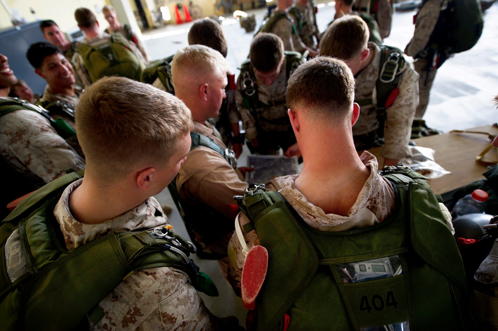 YOKOTA AIR BASE, Japan -- Marine paratroopers assigned to the 31st Marine Expeditionary Unit from Okinawa, Japan, gather to look over a map of where they will be flying for a parachute jump training exercise July 26, 2012 at Yokota Air Base, Japan. Completing this training every 90 days keeps the jumpers ready to deploy throughout the Pacific region. (U.S. Air Force photo by Staff Sgt. Stacy Moless)