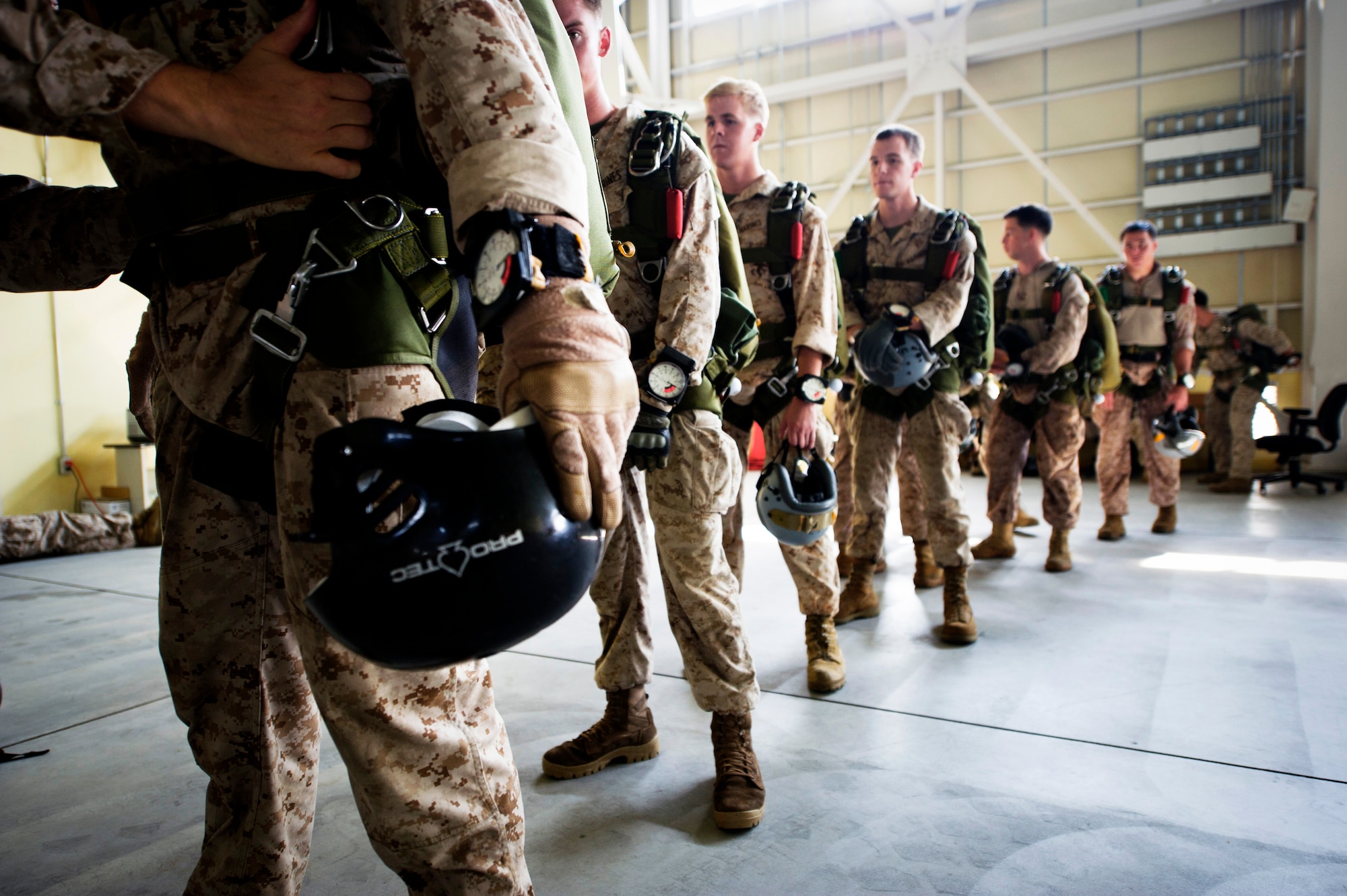 YOKOTA AIR BASE, Japan -- Marine paratroopers from assigned to the 31st Marine Expeditionary Unit from Okinawa, Japan, stand in line for a jumpmaster personnel inspection July 25, 2012 at Yokota Air Base, Japan. The inspection is done before every jump by a qualified jumpmaster to ensure the safety of every paratrooper. (U.S. Air Force photo by Staff Sgt. Stacy Moless)