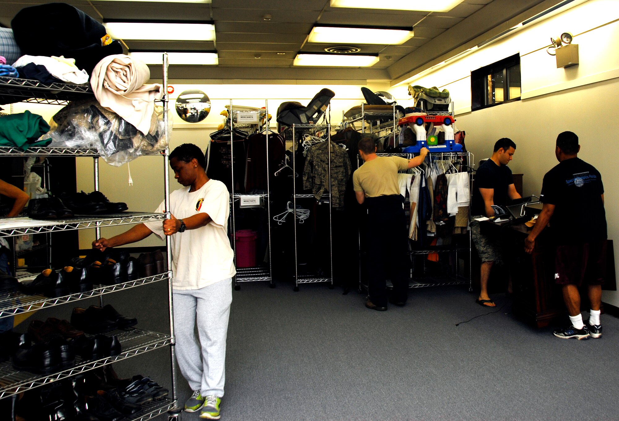 YOKOTA AIR BASE, Japan -- Yokota Airmen work together to move racks containing various items during a four-hour remodeling shift at the Airman’s Attic at Yokota Air Base, Japan, July 26, 2012. The remodel took three weeks to complete. (U.S. Air Force photo by Senior Airman Lynsie Nichols)