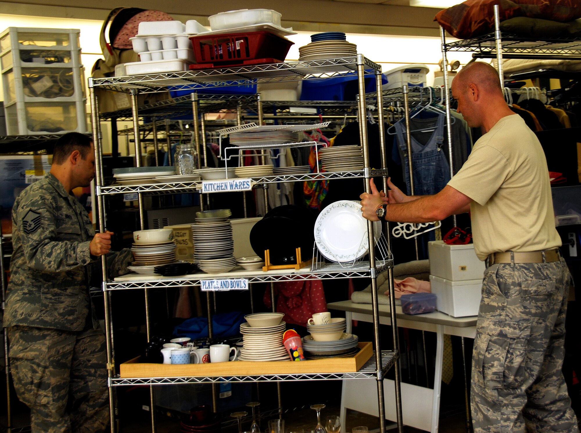 YOKOTA AIR BASE, Japan -- Master Sgt. Anthony Boyer, left, 374th Maintenance Squadron maintenance flight chief, and Master Sgt. Michael Deidrich, 374th Airlift Wing Plans and Programs, superintendent of wing plans and exercises, move a rack of dishes at the Airman’s Attic at Yokota Air Base, Japan, July 26, 2012. Boyer and Deidrich volunteered to help remodel the Airman’s Attic in shifts that were four hours at a time. During the remodel, volunteers laid down new carpet, painted and re-organized the store. (U.S. Air Force photo by Senior Airman Lynsie Nichols)