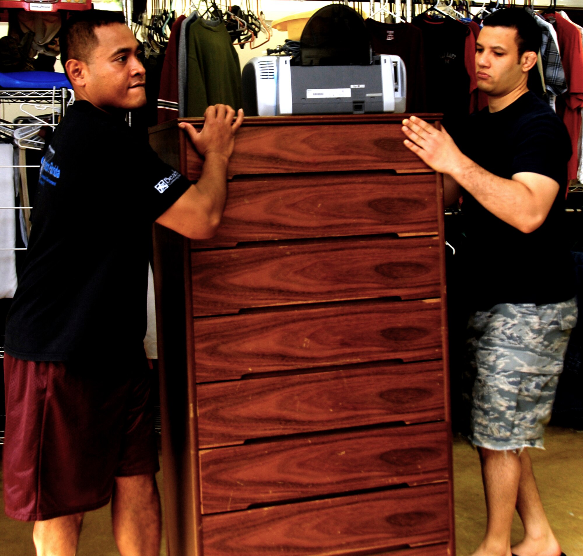 YOKOTA AIR BASE, Japan -- Tech. Sgt. Stan Faimau, left, 374th Logistics Readiness Squadron vehicle maintenance, and Staff Sgt. Aaron Herazel, 374th Communications Squadron network applications supervisor, move a dresser at the Airman’s Attic at Yokota Air Base, Japan, July 26, 2012. Faimau and Herazel volunteered to help remodel the Airman’s Attic in four-hour shifts. (U.S. Air Force photo by Senior Airman Lynsie Nichols)