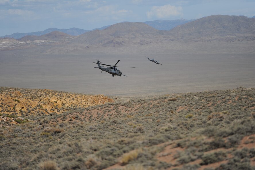 After successfully extracting isolated personnel from the Nevada Test and Training Range July 24, 2012, for a combat search and rescue exercise, and HH-60 Pave Hawk and A-10C Thunderbolt II depart the area.  More than 50 aircraft were used in the recovery effort as part of the scenario during exercise Red Flag 12-4.  (U.S. Air Force photo by Master Sgt. Sonny Cohrs) 