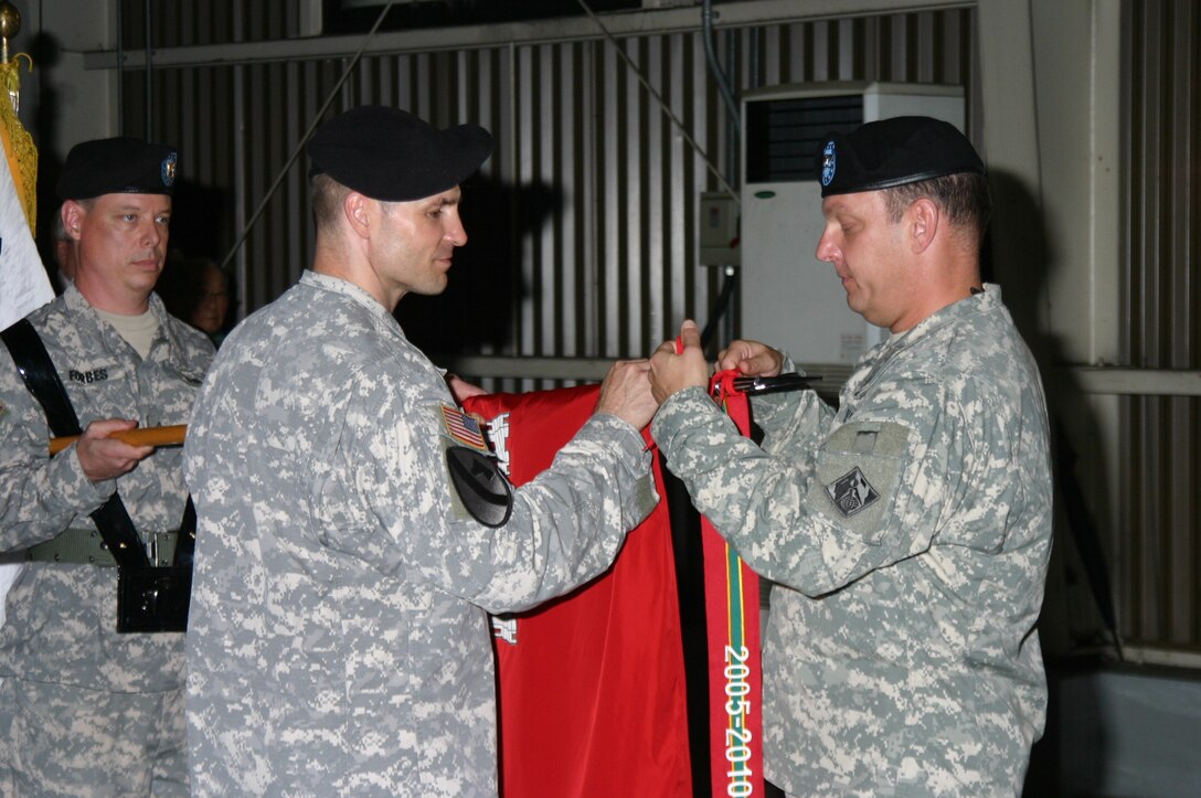 Col. Blair A. Schantz, U.S. Army Corps of Engineers, Far East District Commander, hangs the Army Superior Unit streamer on the District colors during a ceremony June 29. USACE was awarded the streamer for its mission execution during fiscal years 2006-2010. (Photo by O, Sang-song)