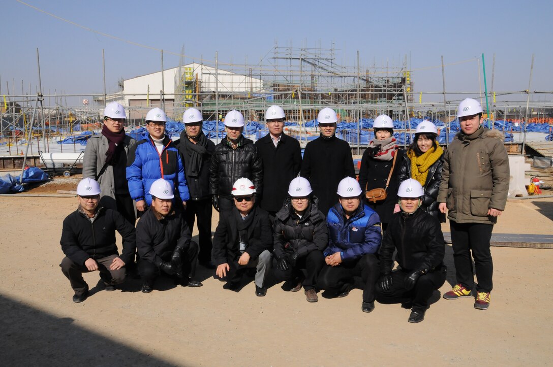 Engineers from the Korean Ministry of National Defense stand in front of an active construction project at USAG Humphreys during the MND Exhange Program Feb. 16