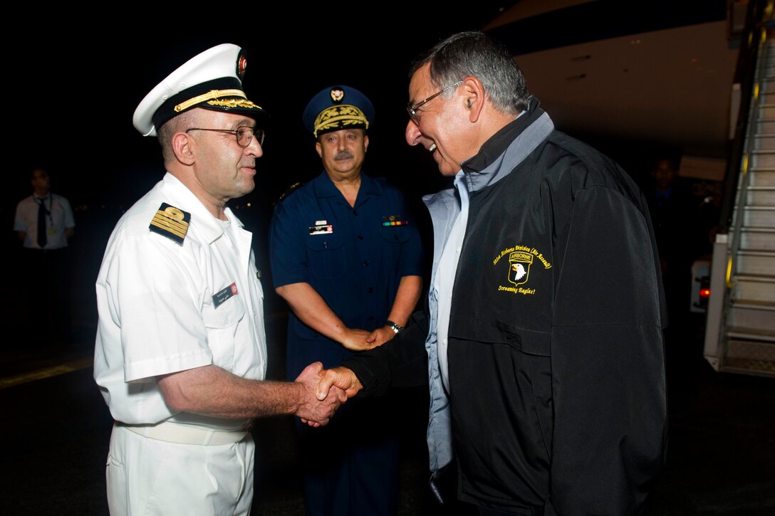Tunisian Maj. Gen. Taieb Laajimi, center, and Tunisian Capt. Mohamed Abid greet U.S. Defense Secretary Leon E. Panetta upon his arrival in Tunis, Tunisia, July 29, 2012.