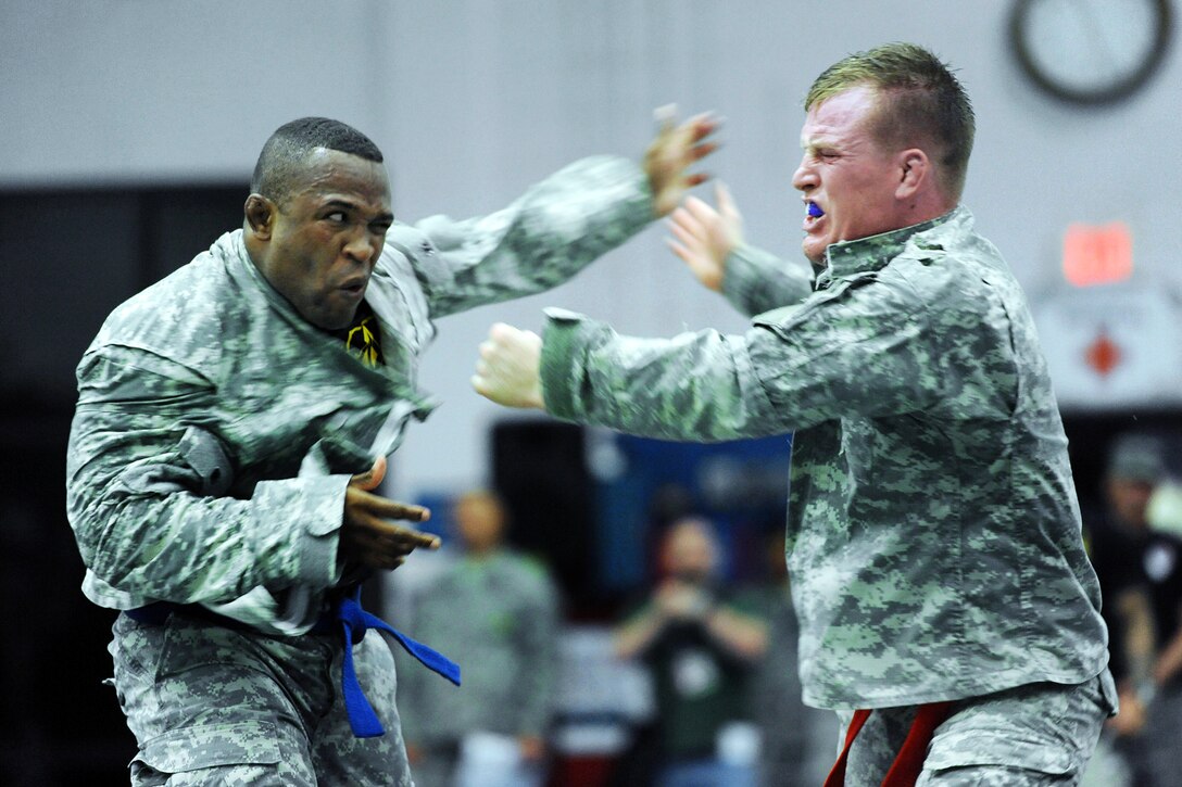 Army 1st Lt. Daniel Midgett, right, exchanges open-handed blows with Army Sgt. 1st Class Jeff Duncan, left, during the 2012 U.S. Army Combatives Championship competition on Fort Hood, Texas, July 26, 2012.