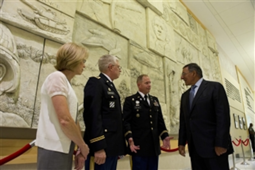 Secretary of Defense Leon Panetta speaks with Pentagon Chaplains Army Lt. Cols. Tom Waynick and Kenneth Williams prior to the Muslim Iftar at the Pentagon on July 25, 2012.  The Iftar is the evening meal when Muslims break their fast during the Islamic month of Ramadan. 