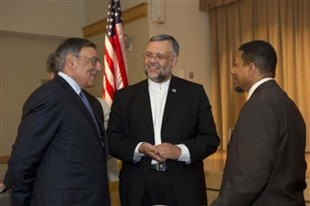 Secretary of Defense Leon Panetta speaks with South African Ambassador Ebrahim Rassol, center, and Imam Talib Shareef who is a retired Air Force chief master sergeant and 4th resident Imam for the Masjid Muhammad at the Muslim Iftar at the Pentagon on July 25, 2012.  The Iftar refers to the evening meal when Muslims break their fast during the Islamic month of Ramadan. 