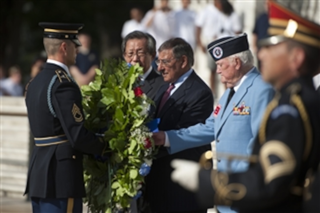 Secretary of Defense Leon E. Panetta, center, is flanked by South Korean Ambassador Choi-Young jin, left, and James Ferris, right, president of the Korean War Veterans Association, as he lays a wreath during a ceremony at the 59th Anniversary of the Korean War Armistice ceremony at the Arlington National Cemetery's Memorial Amphitheatre on July 26, 2012.  