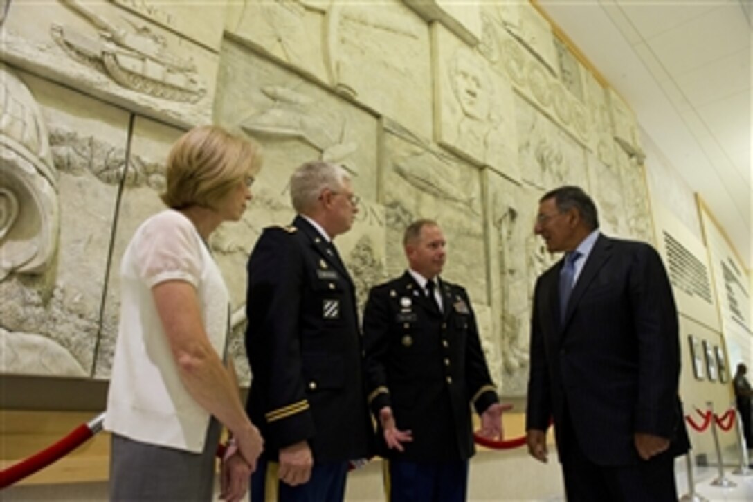 Secretary of Defense Leon Panetta speaks with Pentagon Chaplains Army Lt. Cols. Tom Waynick and Kenneth Williams prior to the Muslim Iftar at the Pentagon on July 25, 2012.  The Iftar is the evening meal when Muslims break their fast during the Islamic month of Ramadan. 