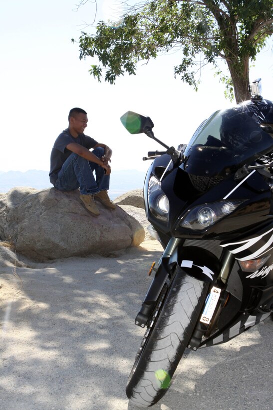A Marine with the Marine Corps Base Camp Pendleton, Headquarters & Support Battalion’s motorcycle club relaxes at a rendezvous point during the H&S Bn. motorcycle club group ride to Long Beach, CA., Jul. 20.  The meeting place served as a chance for the Marines to stretch their legs and discuss the winding roads just traveled.