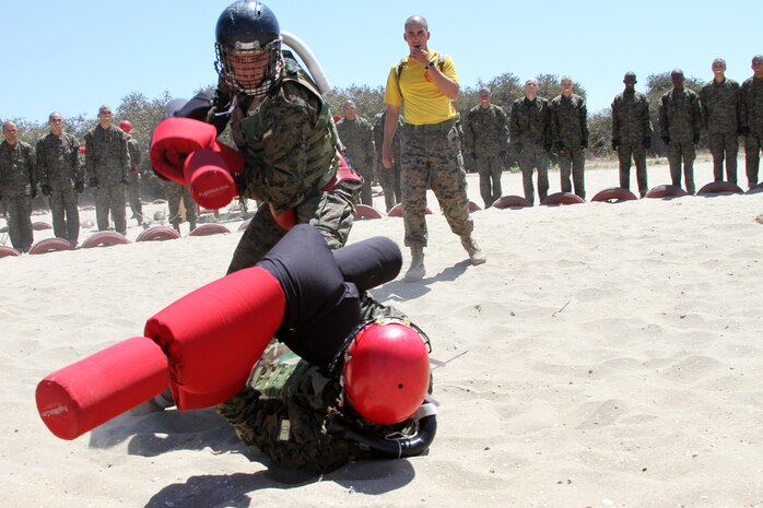 Recruits of Company H, 2nd Recruit Training Battalion, attack each other in a pugil stick fight aboard Marine Corps Recruit Depot San Diego July 24. A direct hit to the head is considered a kill shot. Prior to pugil sticks, recruits completed a bayonet assault course.